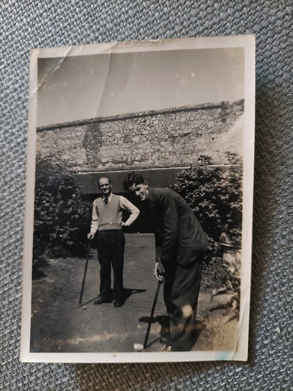 Interviewee's brother William in the foreground of picture playing pitch and put at Heatherside Sanatorium
